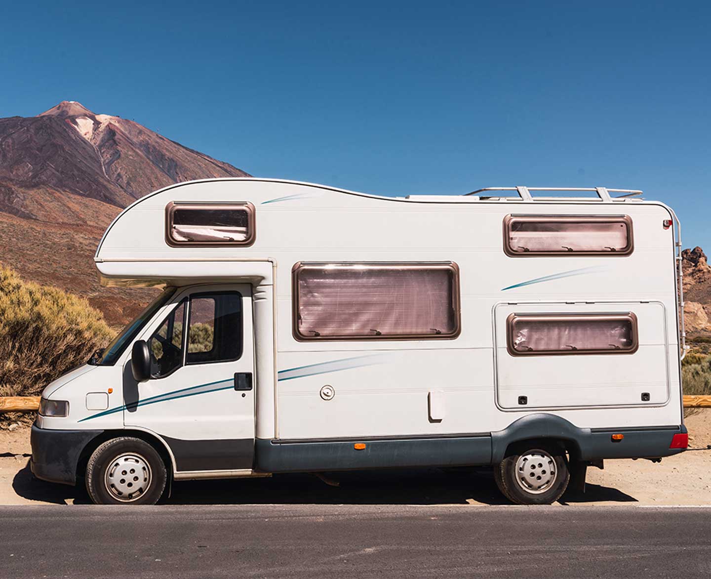 Camper van on road near hill and blue sky 2021 12 09 12 34 12 utc.jpg